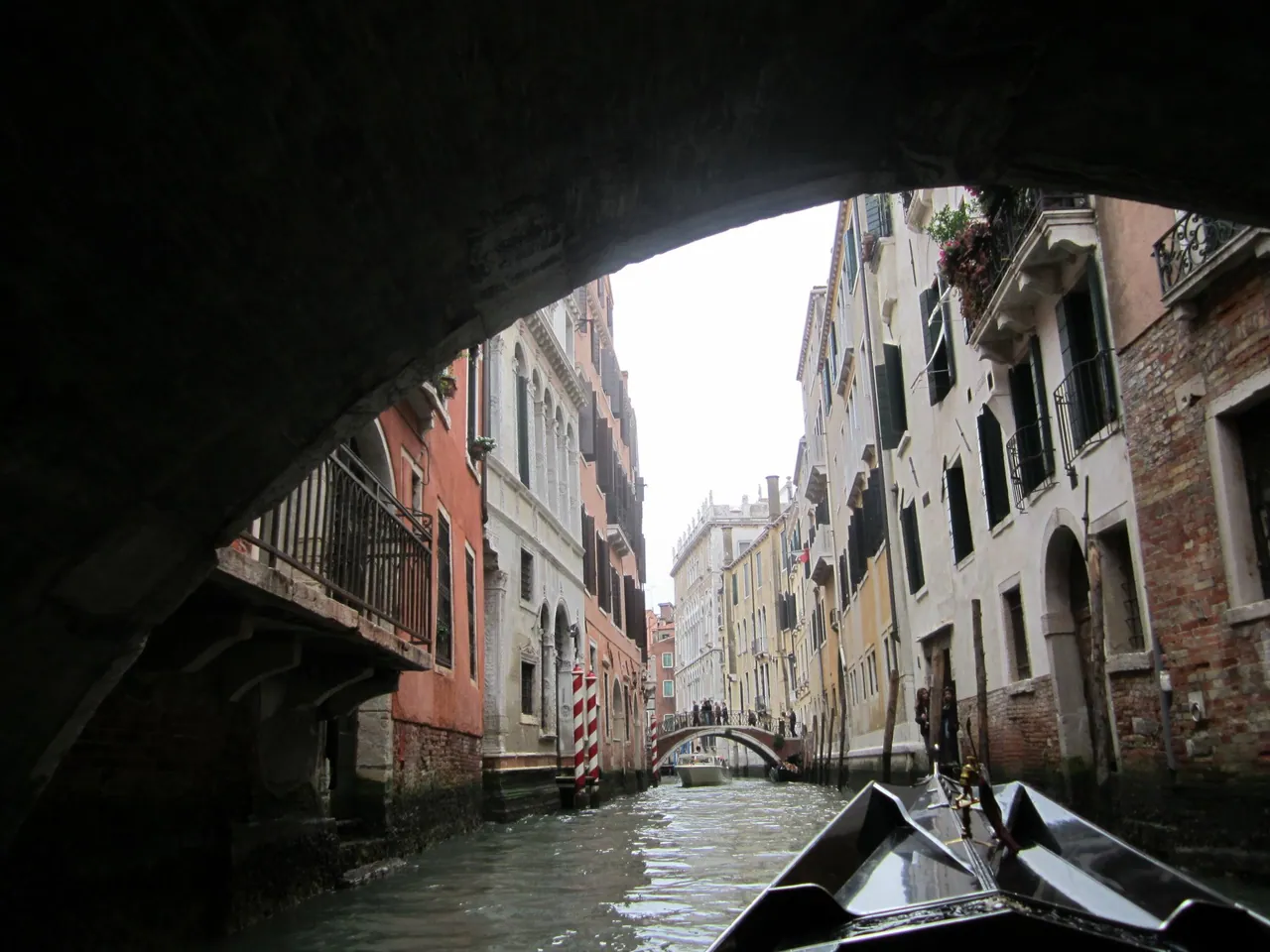 View from a gondola under a bridge in Venice